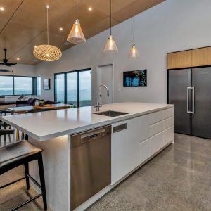 Kitchen renovation, full makeover from Trends magazine. Wood/timber, white benchtop, black detailing.