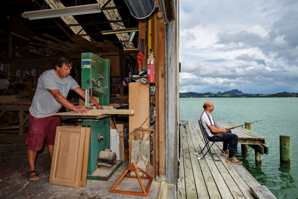 Wooden Earth Creations, father on lunch break fishing at work in the Whangaroa Harbour in the Far North.